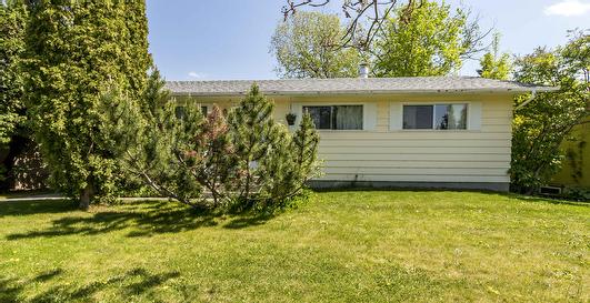 House for sale in Red Deer, fully finished bungalow with a detached garage, beautiful large landscaped yard with a large deck